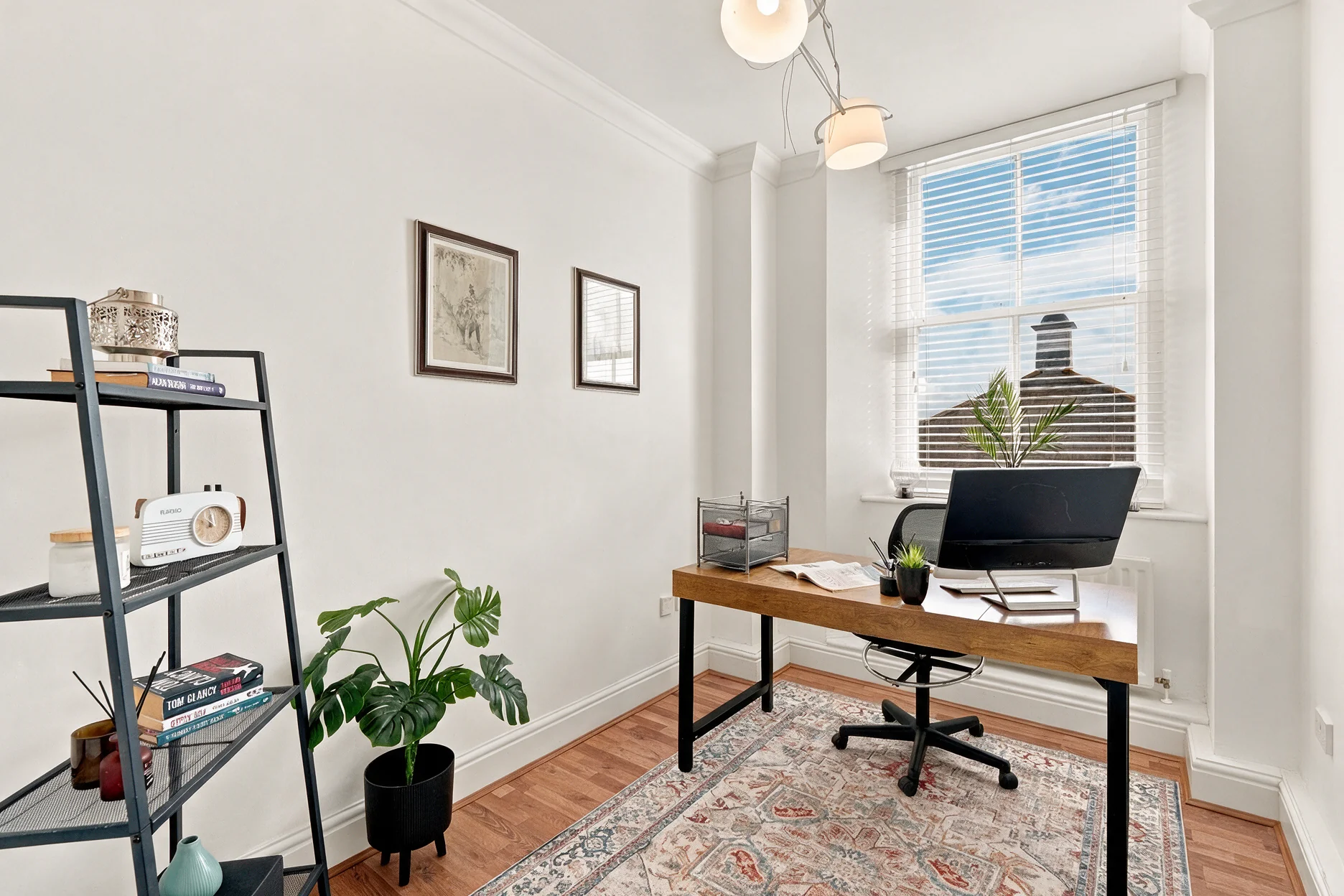 Barrington Grange home office with a wooden desk, shelving and greenery