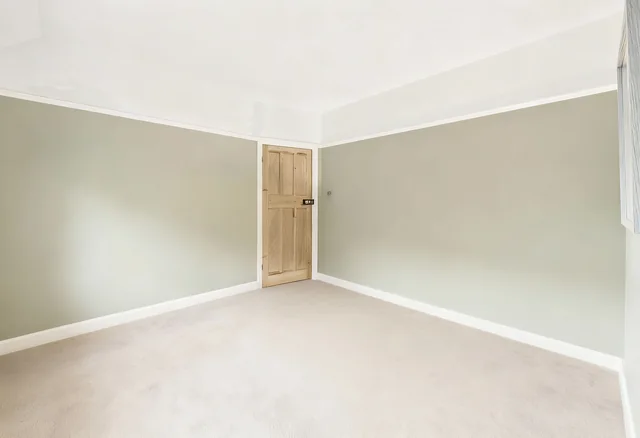 The same bedroom empty, as a viewer would see it in person
